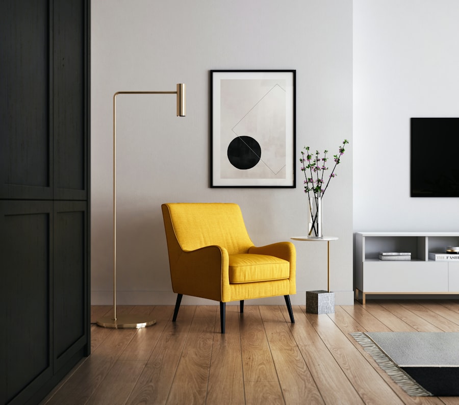 Studio vignette with a mustard armchair, brass floor lamp, and framed artwork
